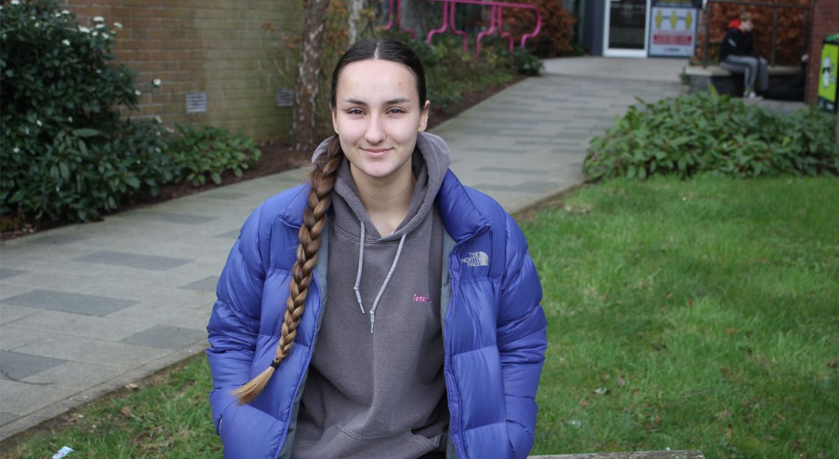 Young woman with brown hair and a blue coat pictured outside SERC's Bangor campus.